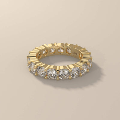 Cushion wedding band in yellow gold with shared prong eternity
