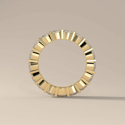 Handmade cushion wedding band with shared prong gold setting

