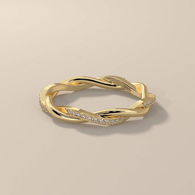 Round cut wedding band with twisted yellow gold shared prong design
