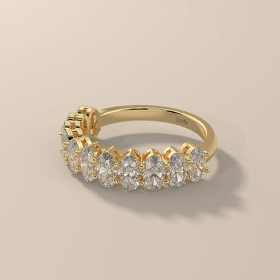 Handmade yellow gold half eternity band with oval moissanite

