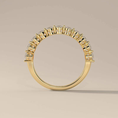 Shared prong oval moissanite band with unique artisan detailing
