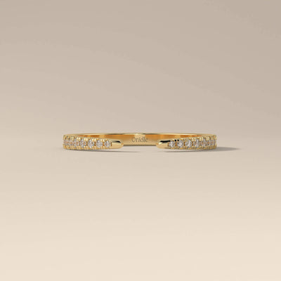 yellow gold wedding band with open gap and round cut stones
