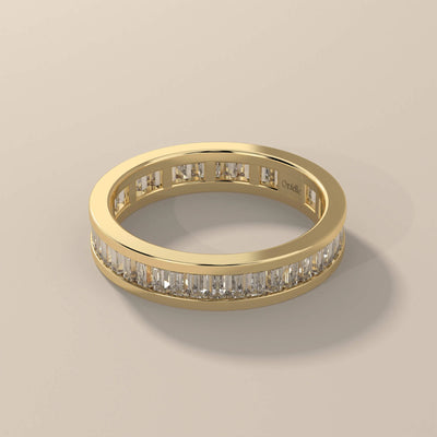 Yellow gold eternity band featuring bezel set accents
