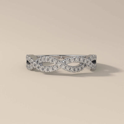 elegant twisted wedding band with round moissanite in white gold
