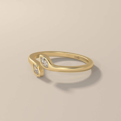 Bezel set wedding band featuring marquise moissanite accents
