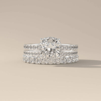moissanite bridal set with cushion cut center and pave details

