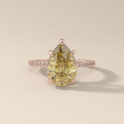 Side round stone pear cut moissanite ring

