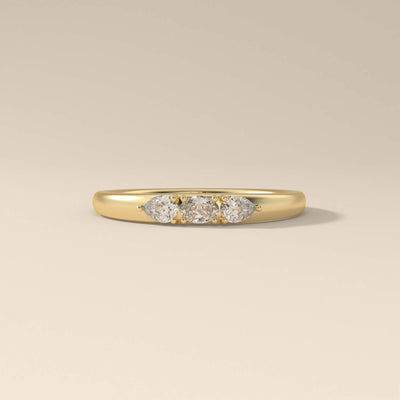 Three stone oval cut moissanite ring in a classic yellow gold prong setting
