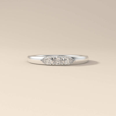 Three stone moissanite ring showcasing oval and pear cut stones
