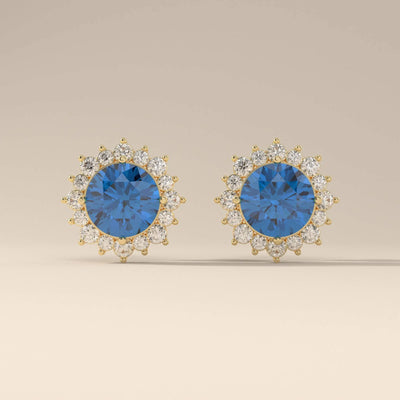 Blue sapphire stud earrings with prong setting and halo design
