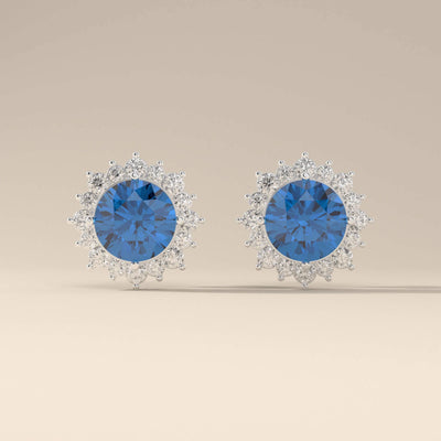 Prong set blue sapphire stud earrings with halo accents
