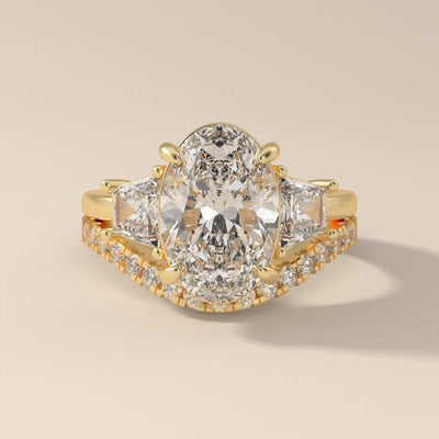 oval cut diamond engagement ring with trapezoid side stone accents
