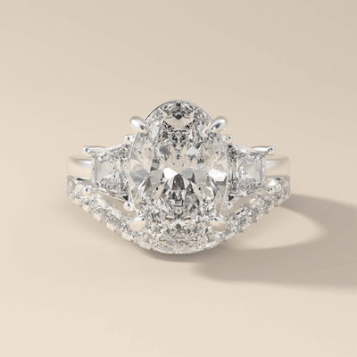moissanite bridal set with oval diamond and trapezoid side stones

