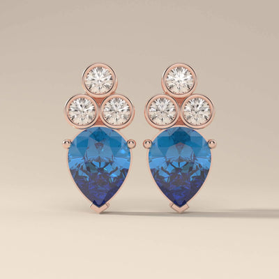 Round cut stone sapphire earrings with bezel and prong design
