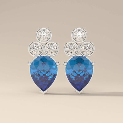 Elegant blue sapphire earrings with pear cut and prong setting
