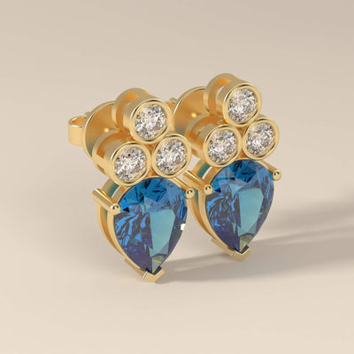 Prong set sapphire earrings with pear and round cut stones
