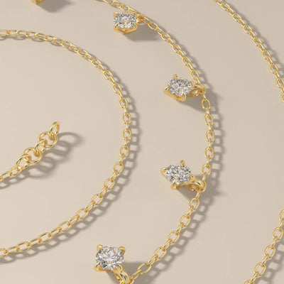 Yellow gold moissanite pendant with seven round stones
