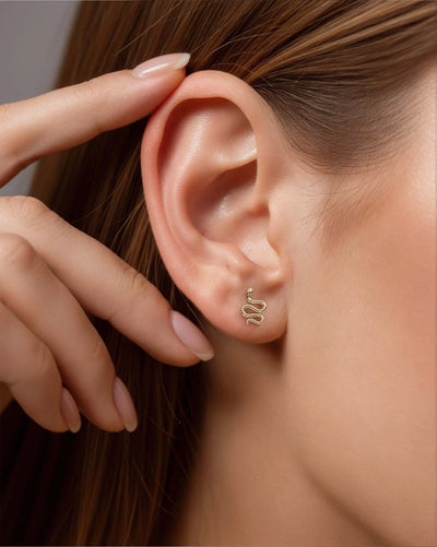 solid gold earrings featuring minimalist snake detailing
