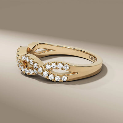 White gold infinity wedding band with prong set round diamonds
