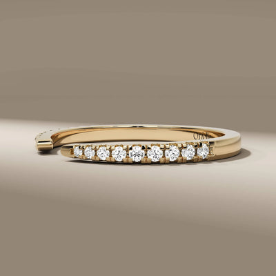 Yellow gold open gap band featuring round cut diamonds
