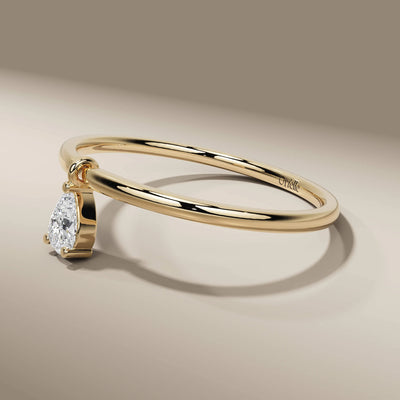 bezel set pear diamond ring in simple minimalist design
