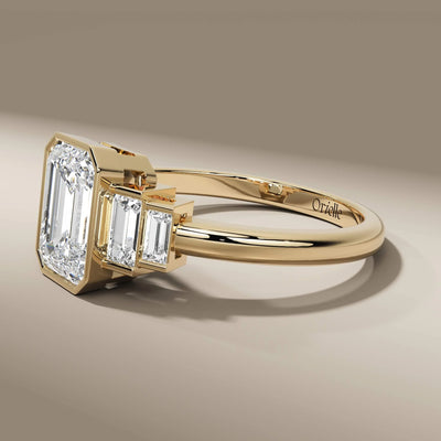 yellow gold emerald cut ring with baguette side stones

