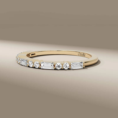 shared prong baguette and round diamond wedding band
