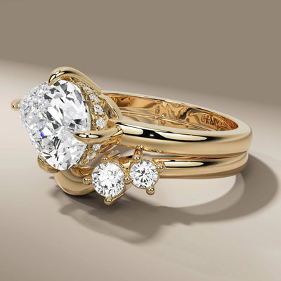 pear cut engagement ring paired with round diamond band
