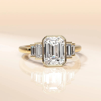Emerald cut moissanite ring with elegant yellow gold band
