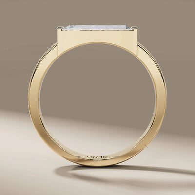 yellow gold engagement ring with tapered baguette solitaire
