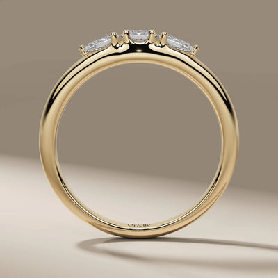 prong setting ring featuring oval and pear cut three stones
