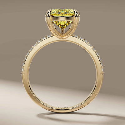 claw prong ring featuring pear cut and side round diamonds
