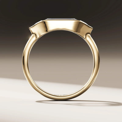 handmade ring with baguette diamond and trilliant side stones
